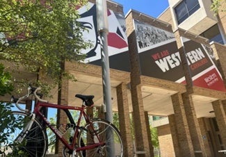 A bike posed in front of Western signage.