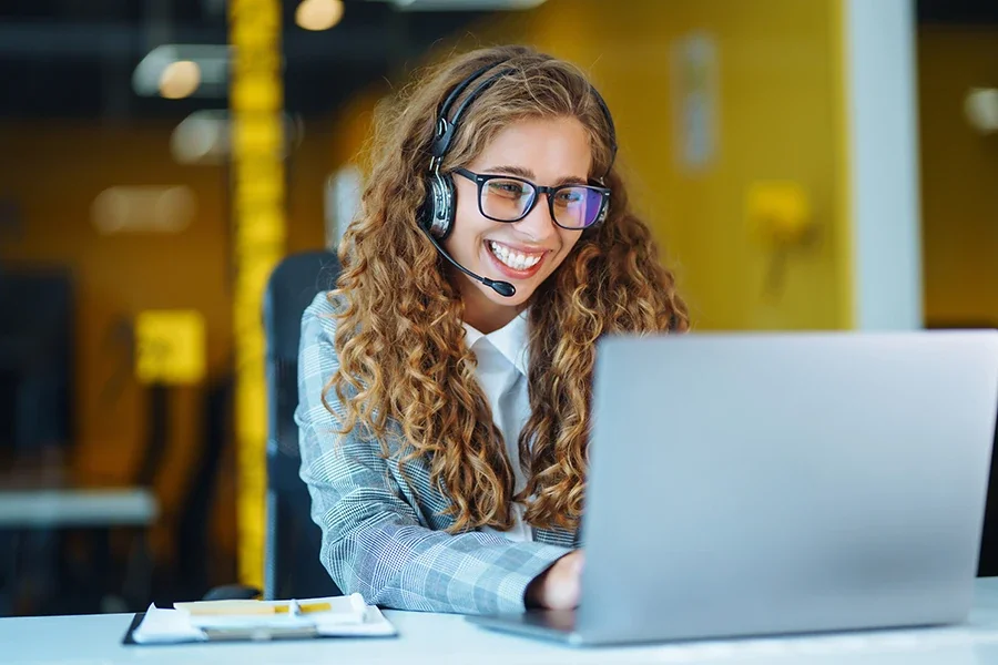 A customer service representative speaks to a customer over a video call.