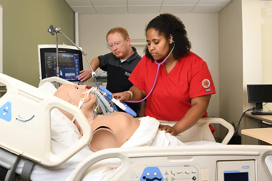 Student practicing techniques on artificial patient