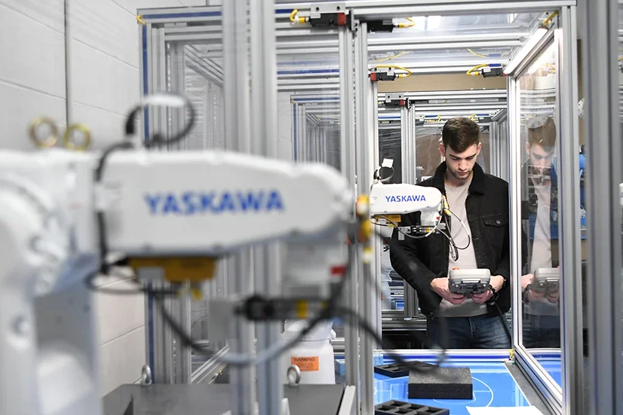 Student in lab programming a robot