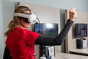 A student wears a virtual reality headset in a learning environment.