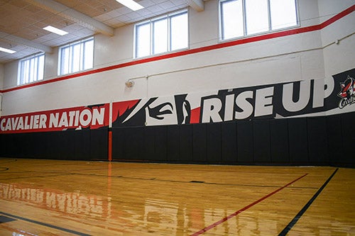 A gymnasium area has Western-themed graphics for motivation.