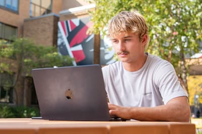 Student studying in the courtyard