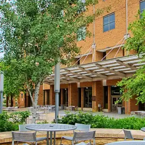 Tables outside the Lunda Center, with the Cleary Courtyard and Kumm Center in the background