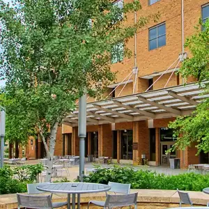 Tables outside the Lunda Center, with the Cleary Courtyard and Kumm Center in the background