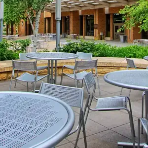 Tables outside the Lunda Center, with the Cleary Courtyard and Kumm Center in the background