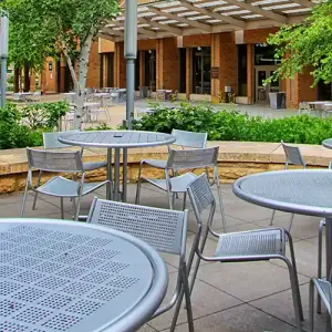 Tables outside the Lunda Center, with the Cleary Courtyard and Kumm Center in the background