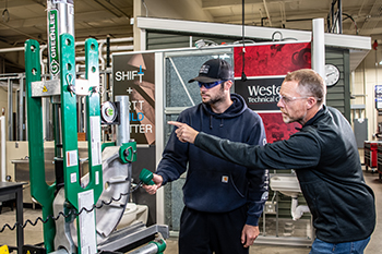 Western apprenticeship instructor working with a student