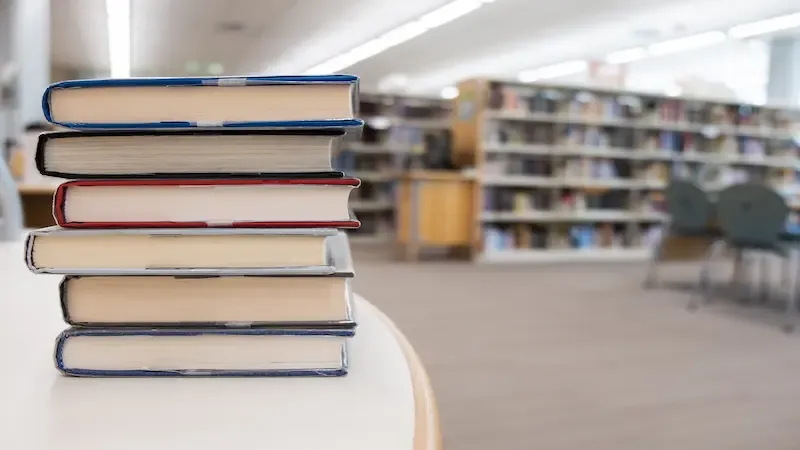 Stack of books on a table at a library
