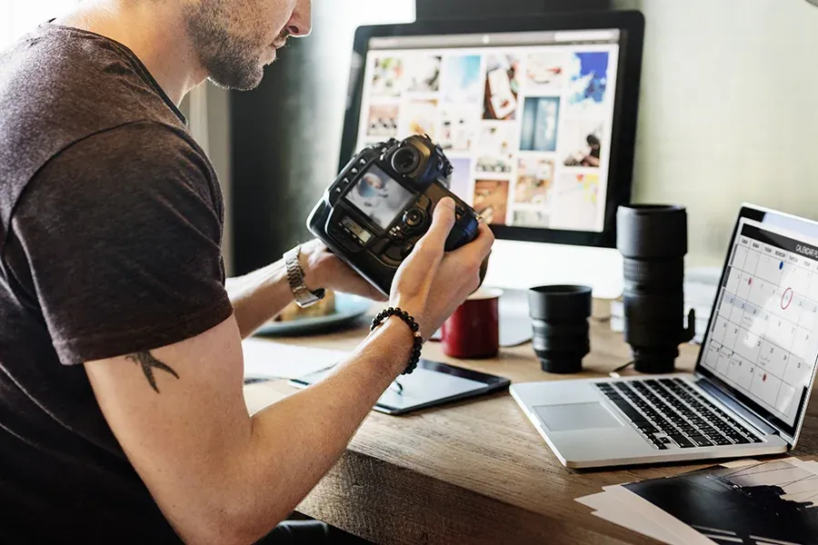 A student views his images on his digital camera at his work station.