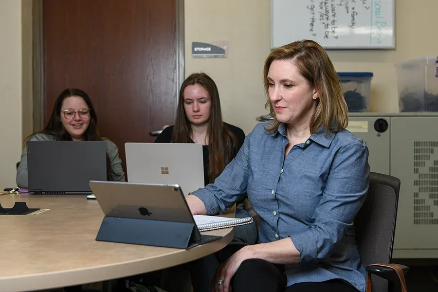 Three people on computers