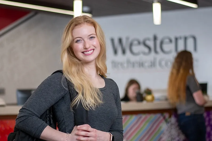 A smiling female student in Western's Welcome center
