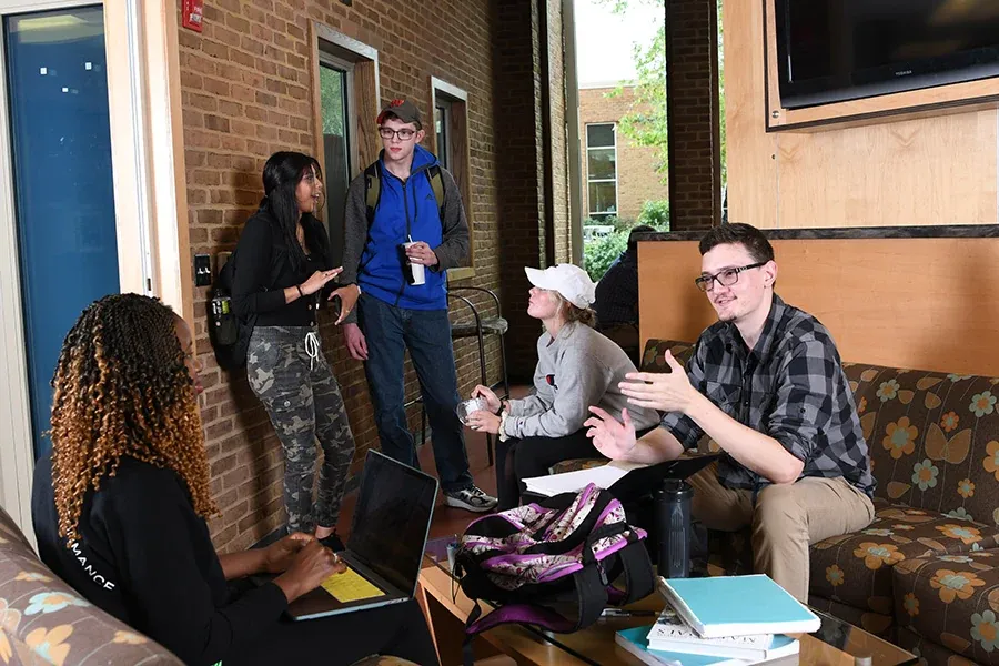 A group of students gathered and talking in the Union Market at Western