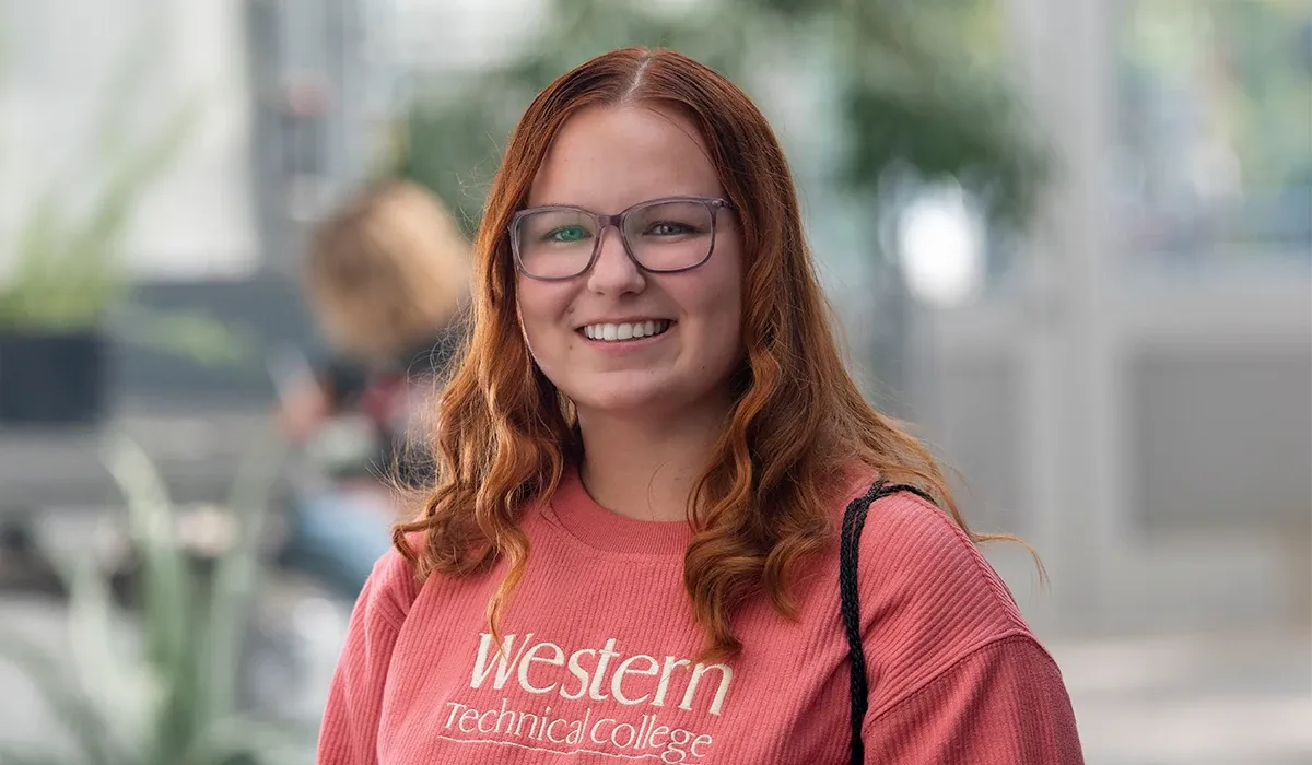 A female Western student walking outside on campus