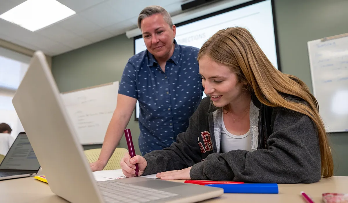 A Western student and instructor work together in a classroom
