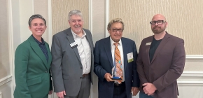 : WTCS President Layla Merrifield, Western President Roger Stanford, Award Recipient Ron Wanek, and Western Associate Vice President of Workforce and Innovation Josh Gamer are pictured as Ron accepts the 2025 Technical Education Champion Award during the WTCS District Boards Association meeting on October 17.